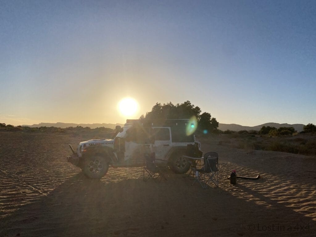 Jeep at a wild camp near the Lost City of Bah Haoudou at sunset in Morocco
