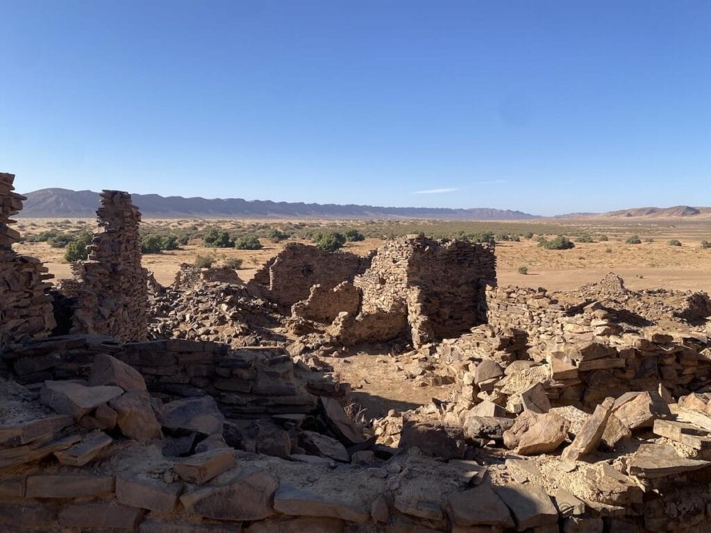The Lost City of Bah Haoudou with desert plains and rocky mountains in Morocco