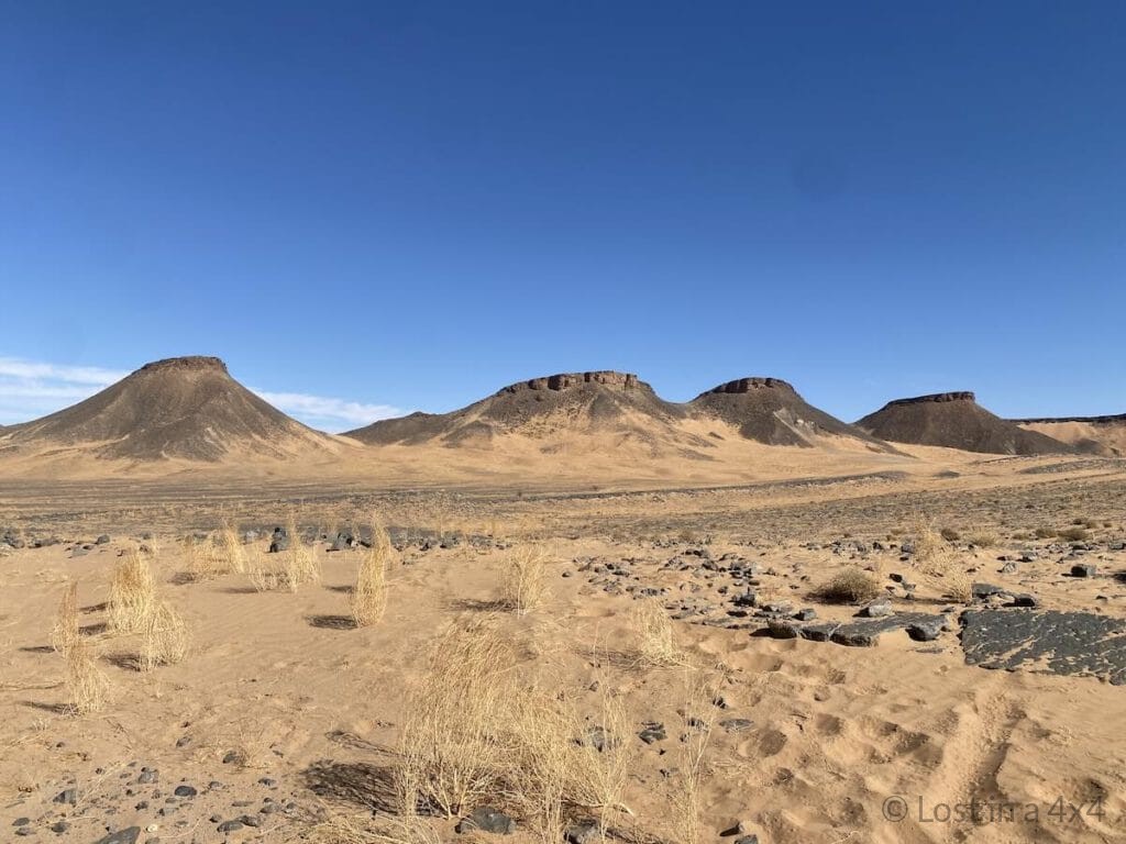 Off-road Jeep trail crossing rocky mountains in the Moroccan desert