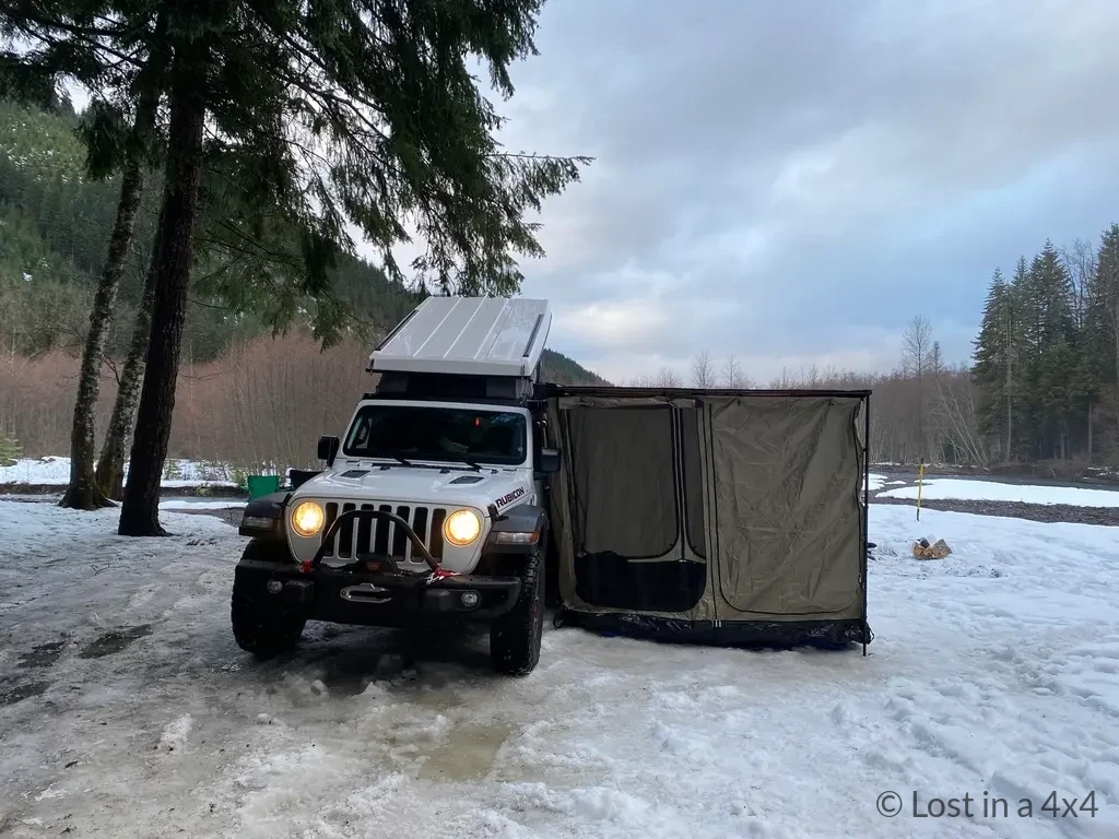 ARB touring awning set up on Jeep during snowy wild camping overland setup