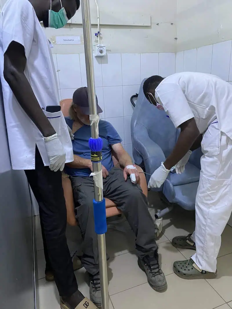 Brett with nurses monitoring vital signs in observation room at Hôpital de la Paix in Ziguinchor Senegal.