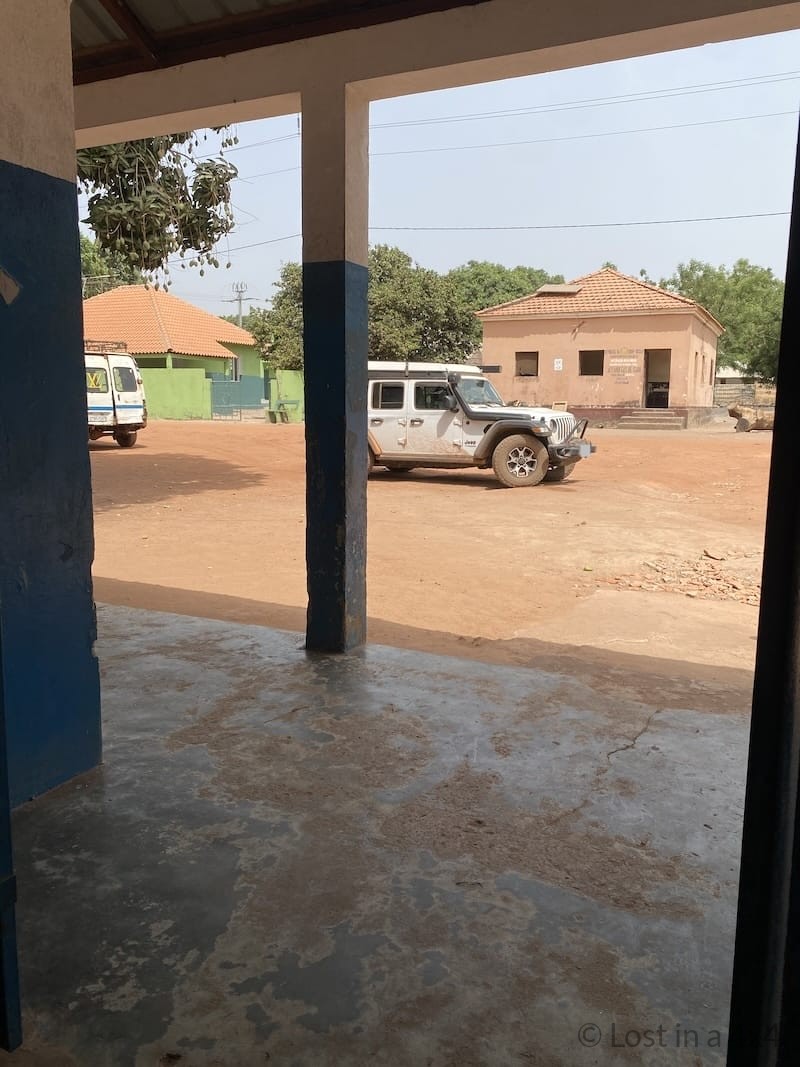 Jeep parked in front of the Guinea-Bissau customs office at the border during an overland journey.