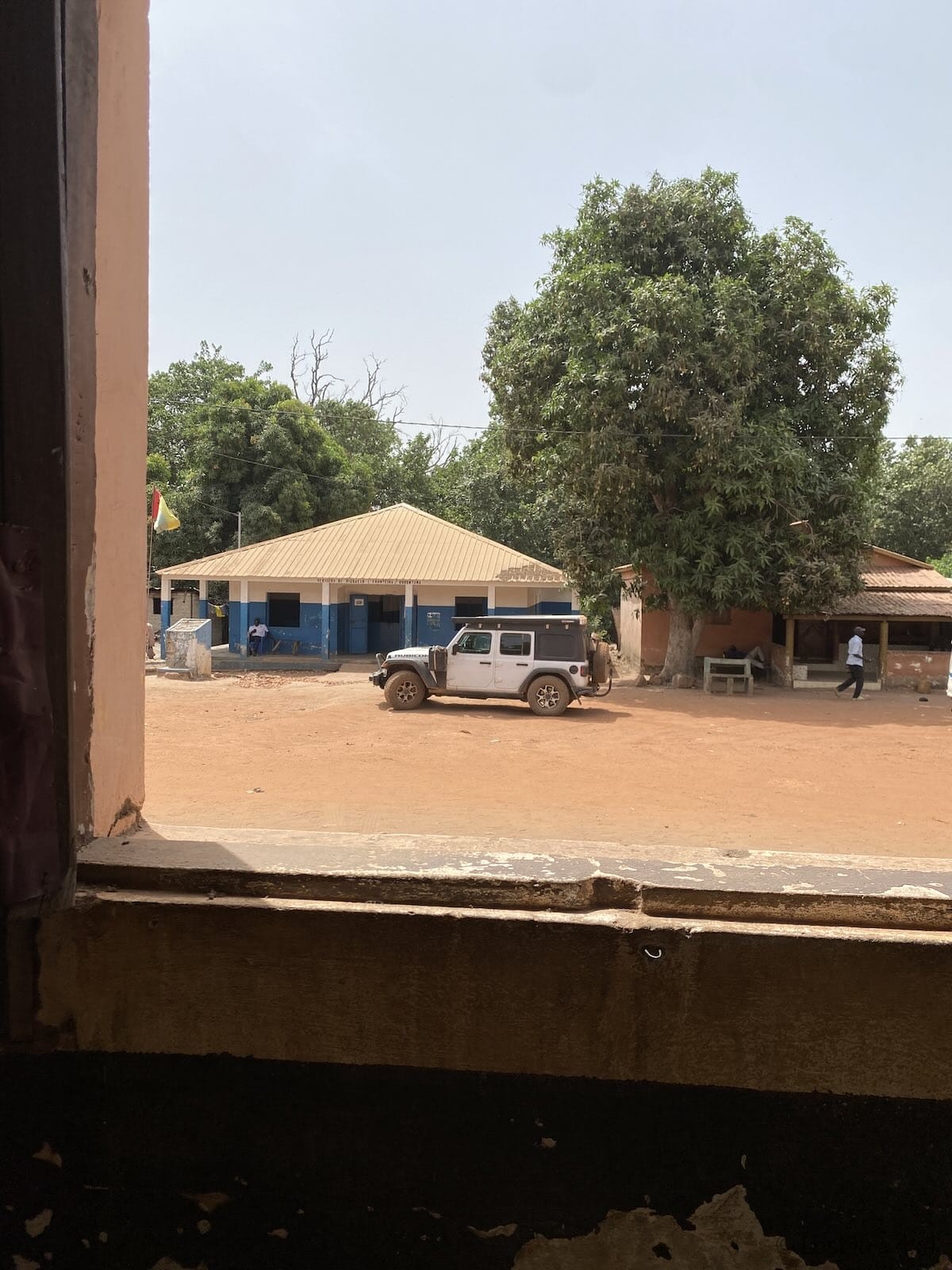 Jeep parked at the Guinea-Bissau immigration office at the border where travelers receive their exit stamp.