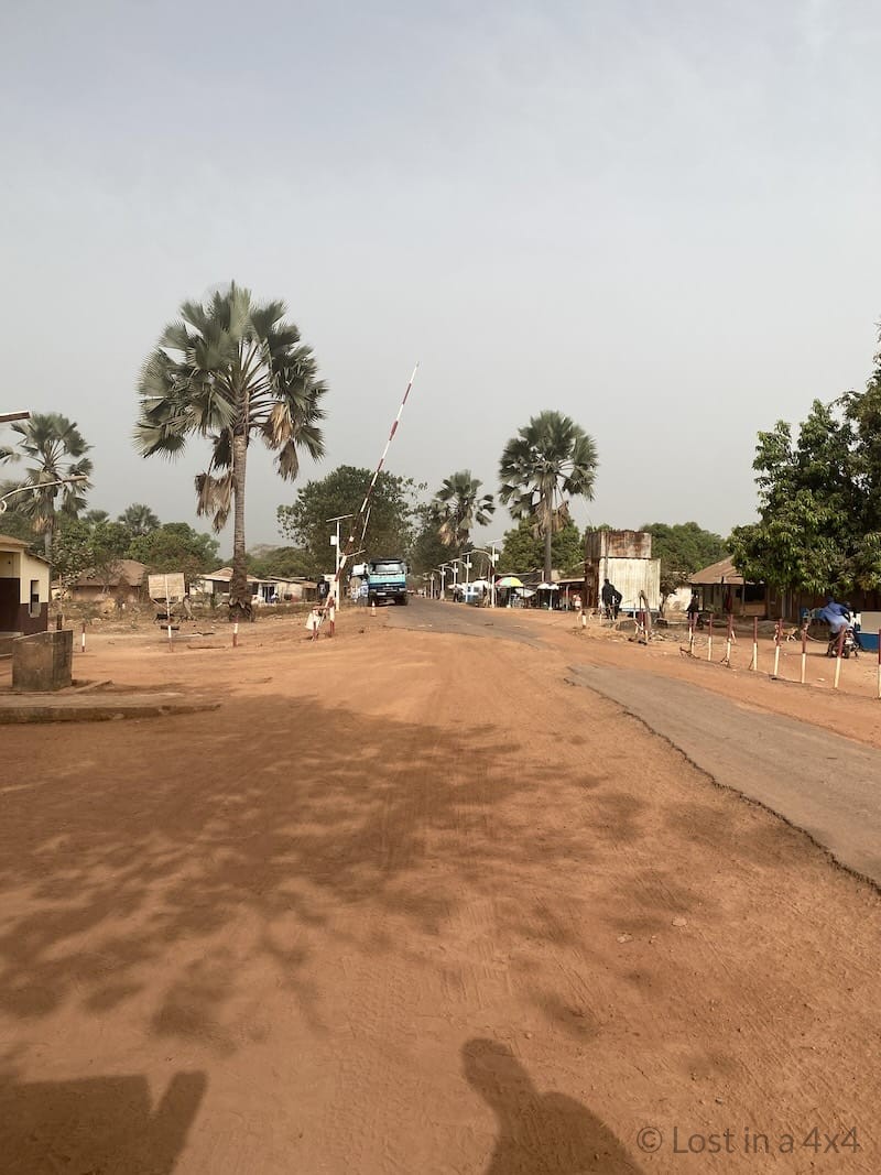 Roadblock at the entrance of the Djegue border post in Guinea-Bissau during an overland border crossing from Senegal.