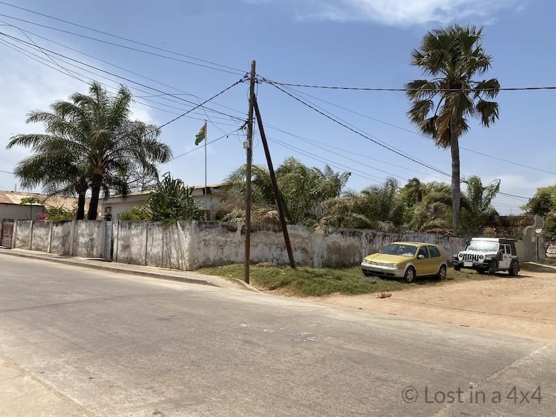 Jeep Wrangler parked outside the Consulate of Guinea-Bissau in Ziguinchor, Senegal during an overland visa application journey through West Africa.