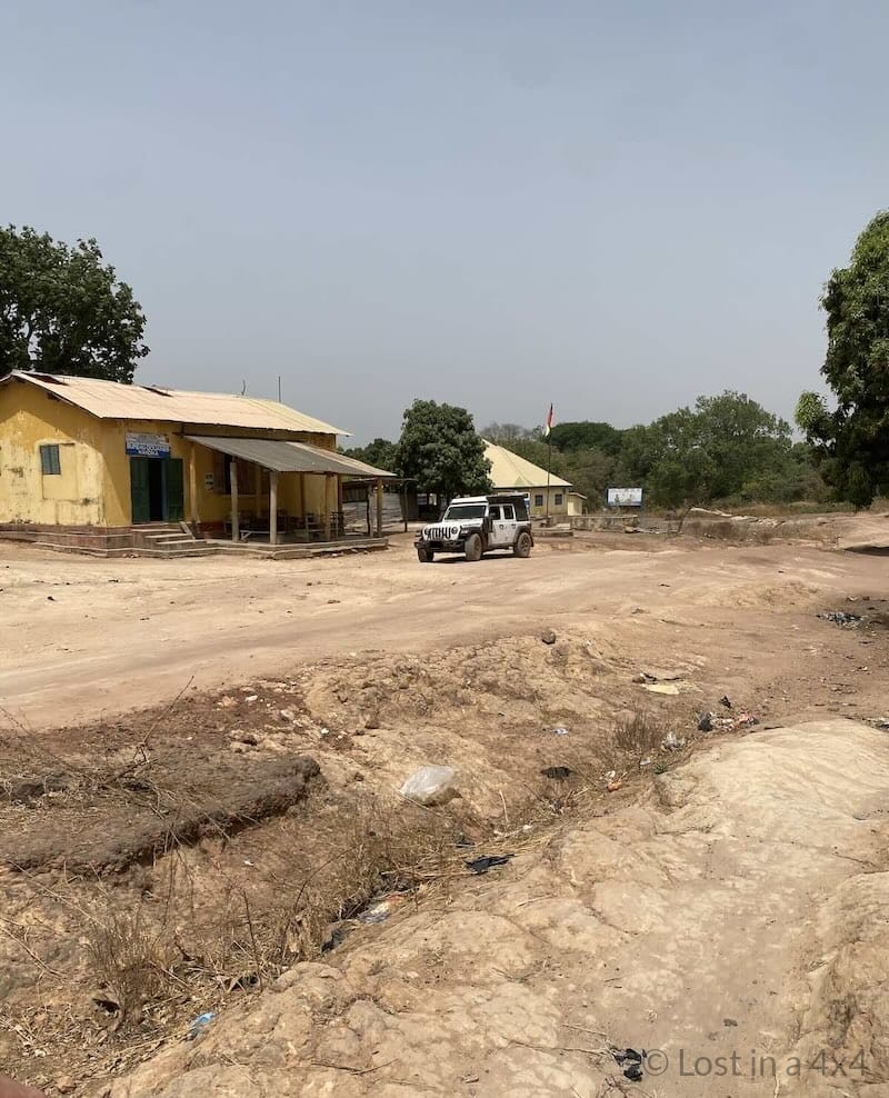 Jeep parked in front of the Guinea customs (douane) office at the border post.