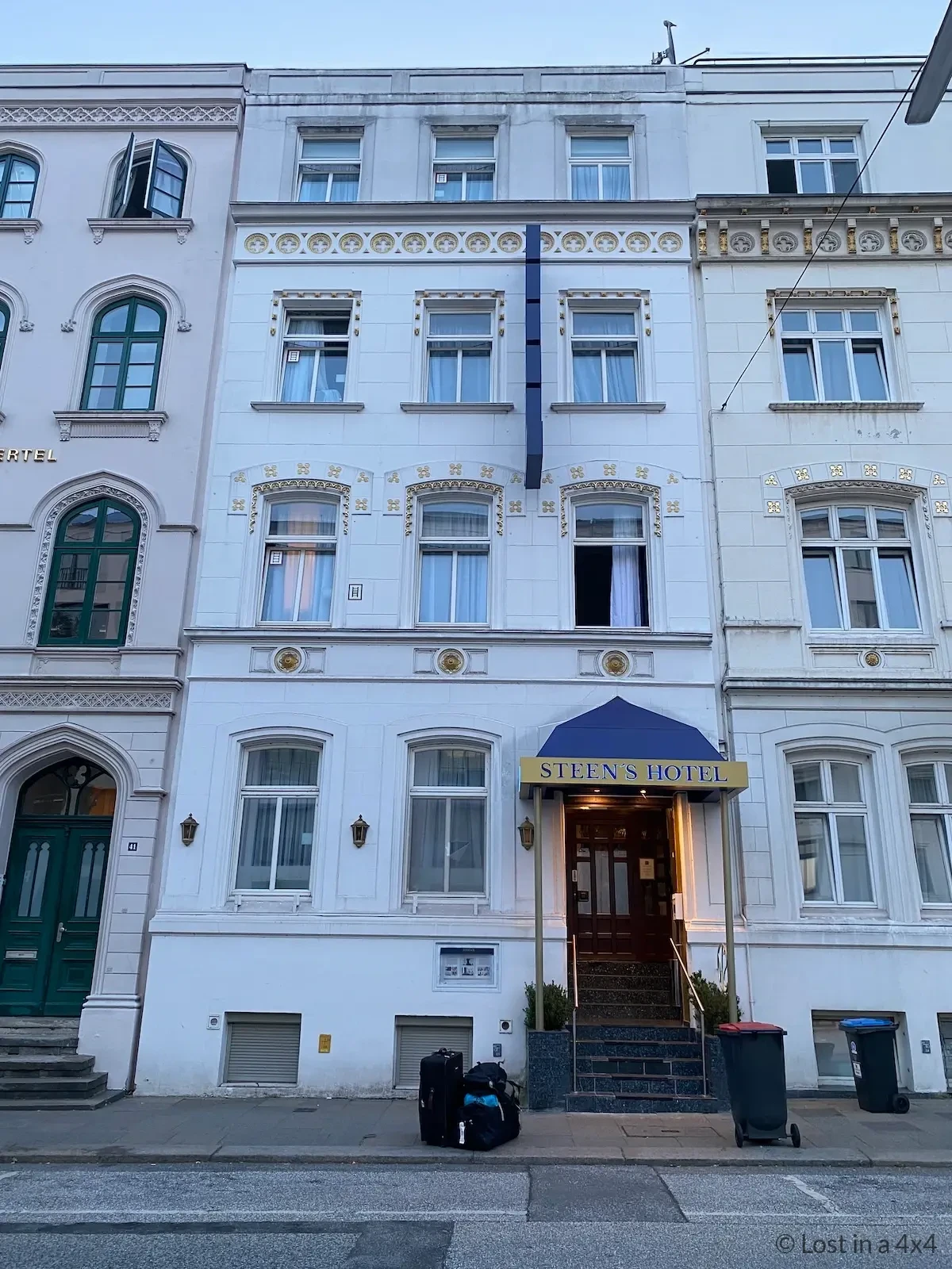 Suitcases outside hotel in Hamburg while waiting for taxi to pick up Jeep at the port