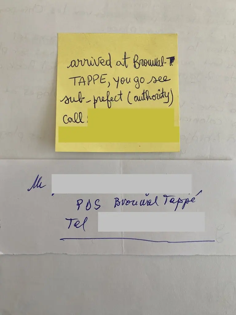 Handwritten contact note from government official in Pita Guinea during overland Africa trip