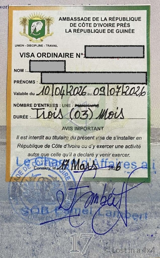 Ivory Coast visa sticker in passport issued at the embassy in Conakry, Guinea for overland travel in West Africa.