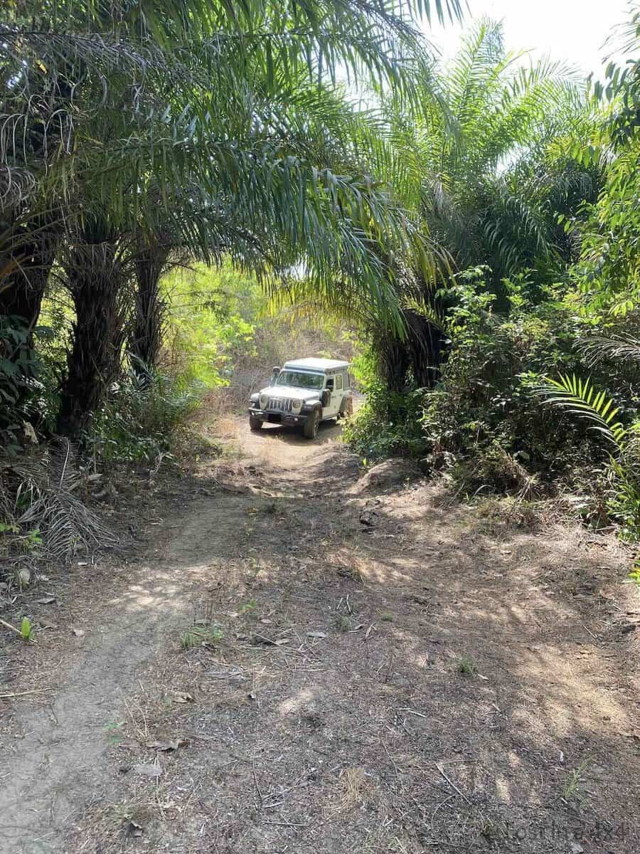 eep Wrangler Rubicon at bottom of hill on dirt road before climbing in Guinea mountains during overland Africa trip