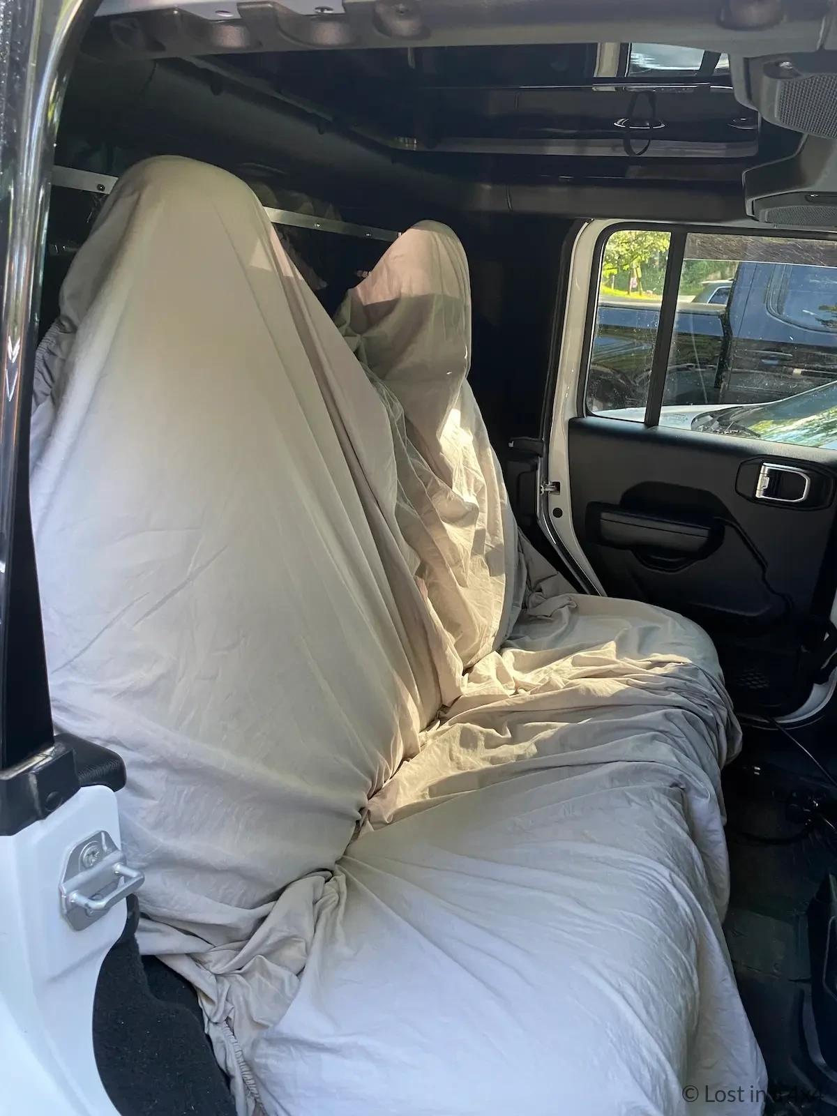 Jeep back seats covered with blankets to protect interior during shipping from USA to Europe