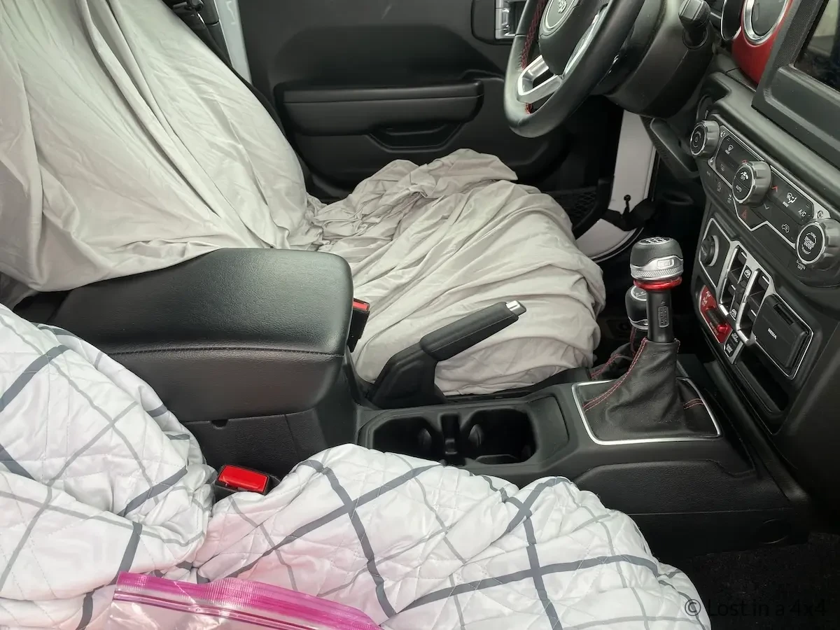 Jeep front seats covered with blankets to protect interior during shipping from USA to Europe