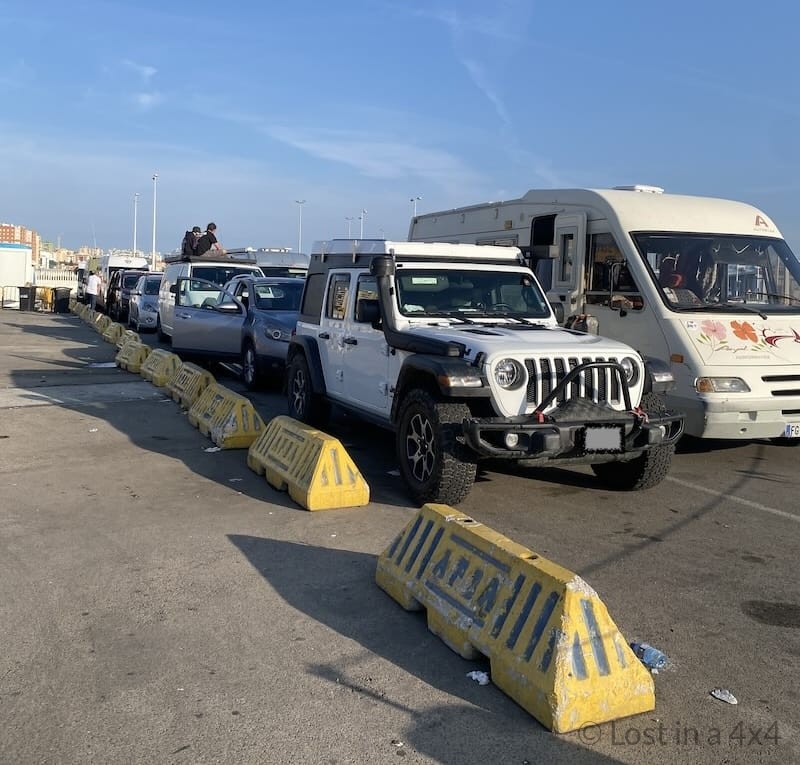 Jeep waiting in a queue with other overland vehicles at the port of Algeciras before boarding the ferry to Morocco