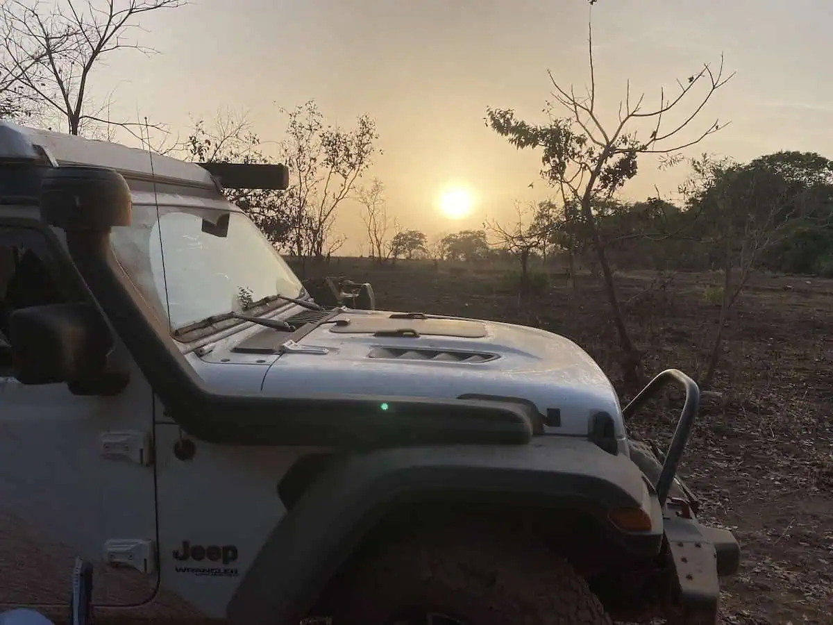 Jeep Wrangler Rubicon at sunset during wild camping on the way to Les Échelles de Djinkan in Guinea