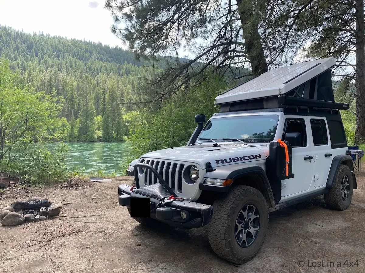 Jeep Wrangler wild camping by river in Montana with MORryde jerry can mount and Ursa Minor pop top tent