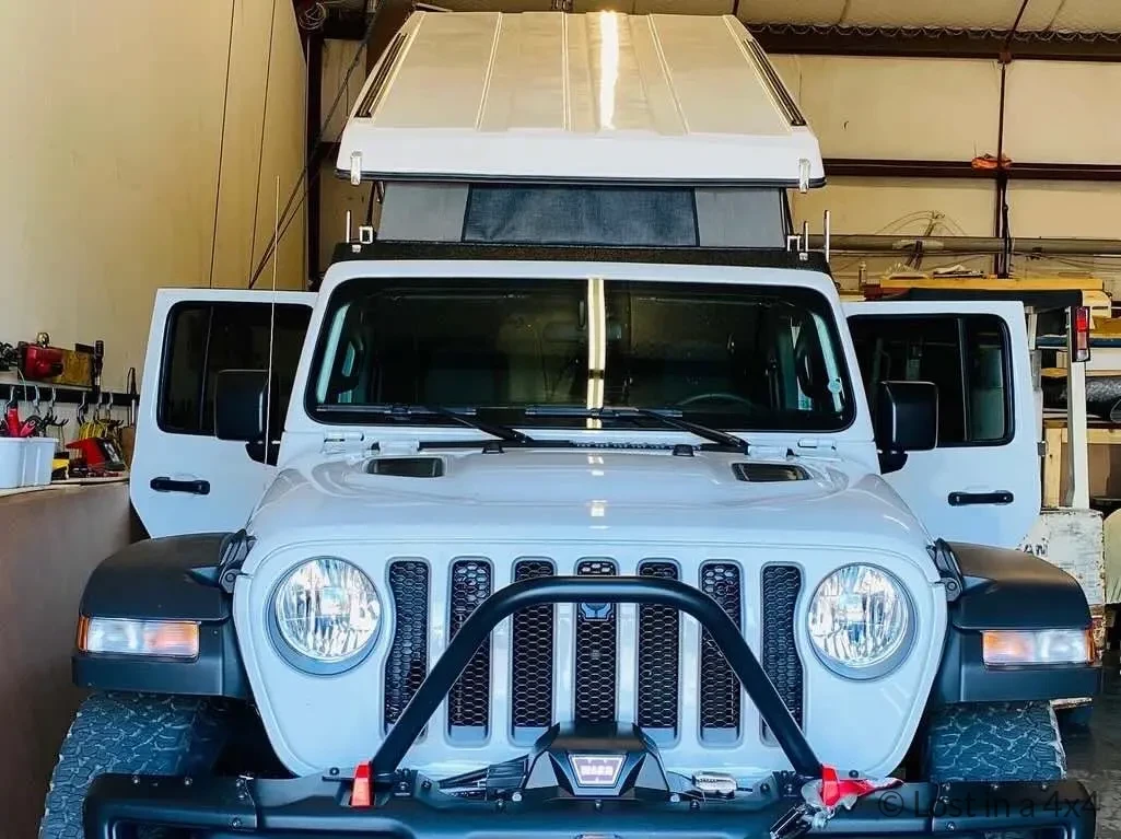 Front view of a Jeep Wrangler Rubicon with Ursa Minor pop-top roof camper installed in Oregon.