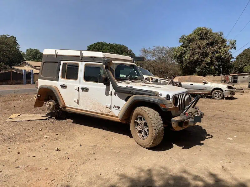 Jeep Wrangler Rubicon lifted without tire during repair in Labé Guinea.