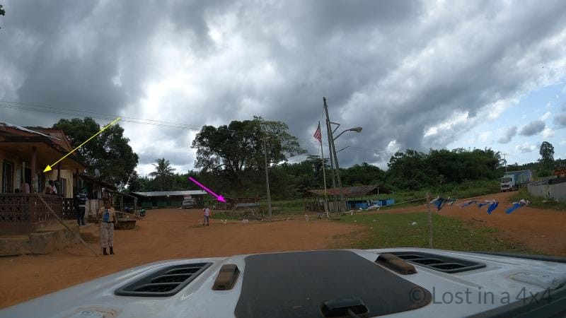 View from inside a Jeep Wrangler driving onto the ferry crossing the Cavalla River between Liberia and Côte d’Ivoire during overland travel.