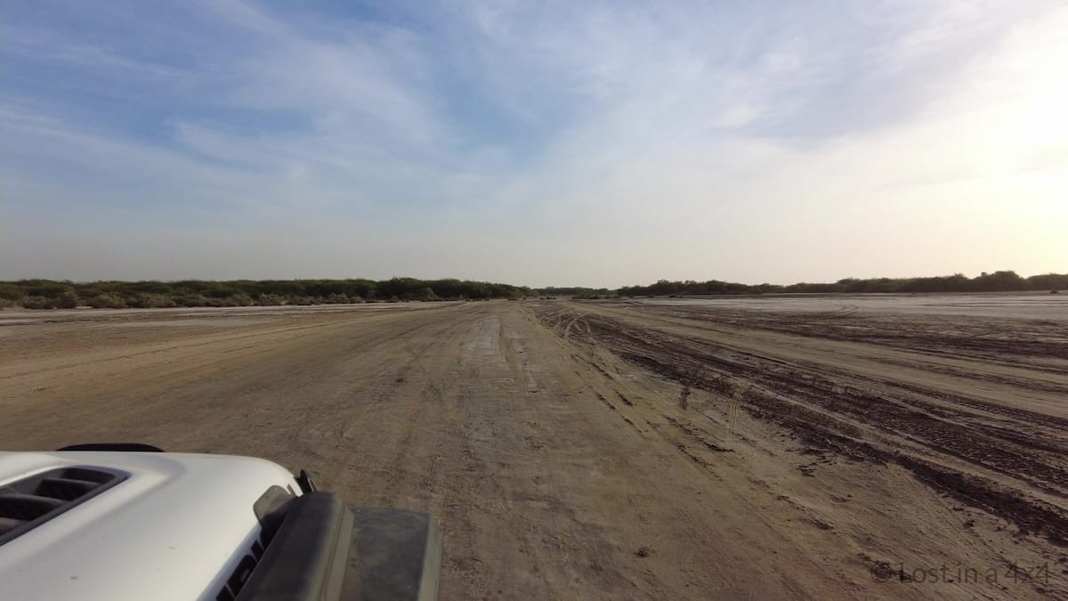 Overland Jeep driving along a dirt road in Senegal
