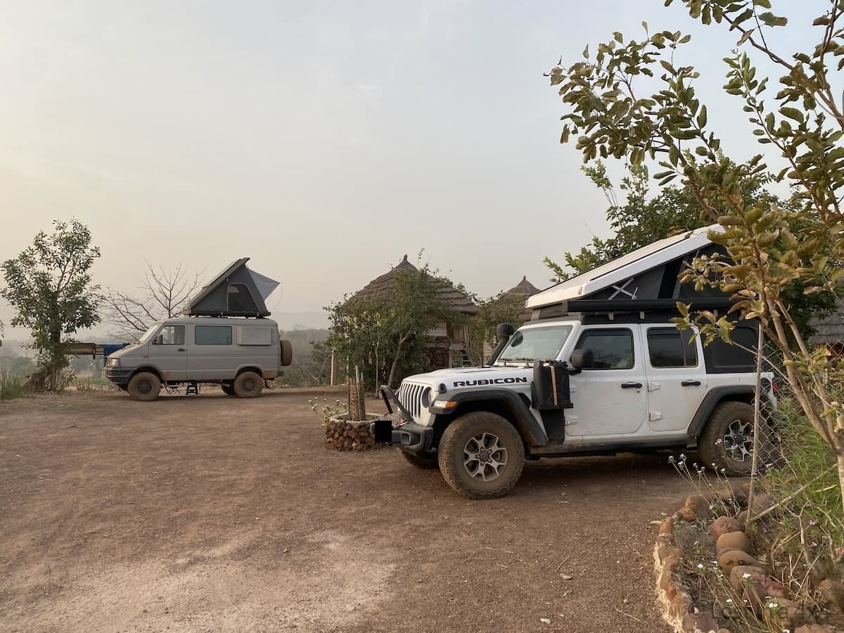 Overland Jeep with Ursa Minor pop up tent set up at Campement du Fleuve in Senegal beside another overland vehicle