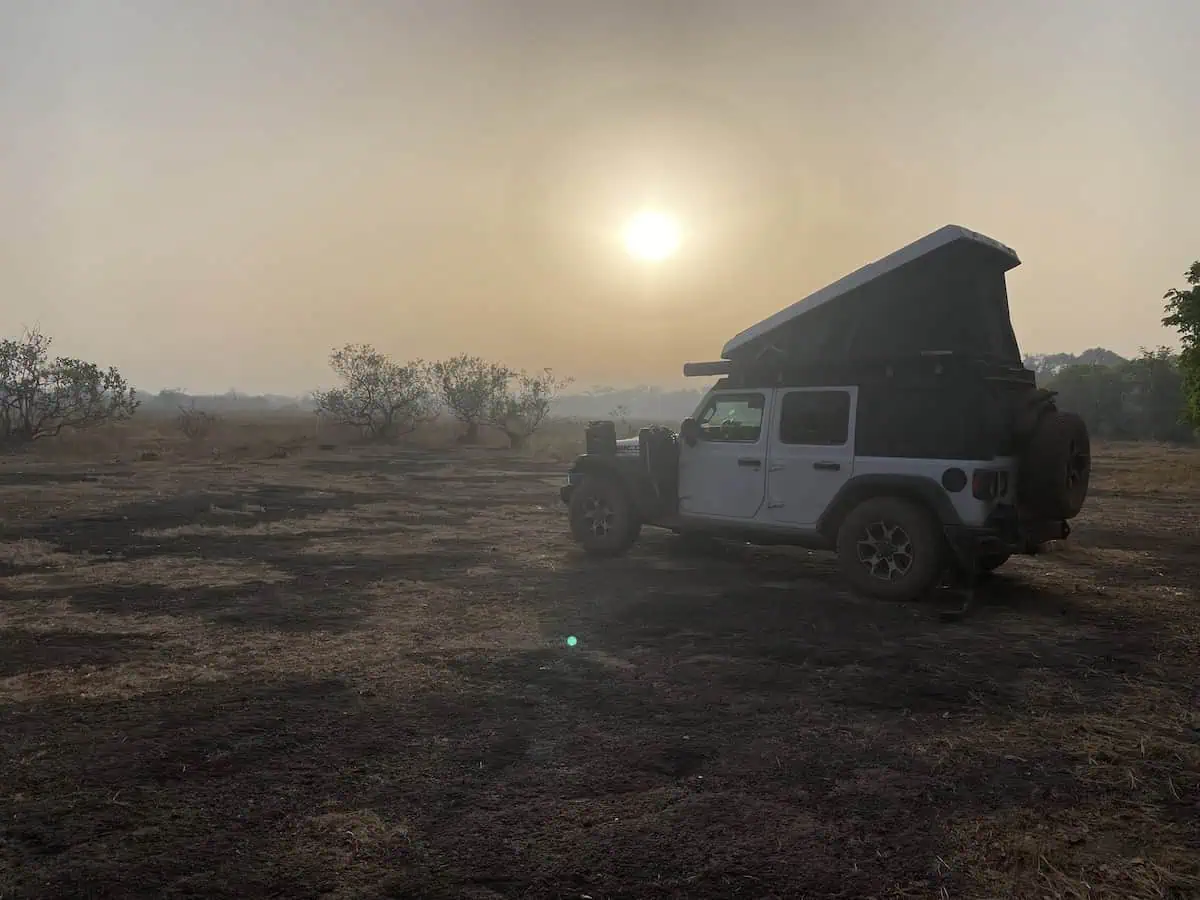 Overland Jeep with Ursa Minor roof top tent at a scenic wild camp near Koundara in Guinea