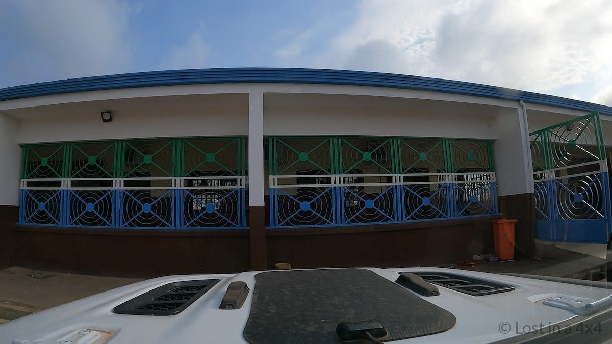 View from inside a Jeep Wrangler Rubicon parked at the Sierra Leone immigration and customs border post during a West Africa overland trip