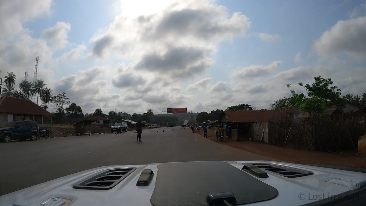 Road tax checkpoint at the Sierra Leone border seen from inside a Jeep Wrangler Rubicon during an overland journey from Guinea into Sierra Leone