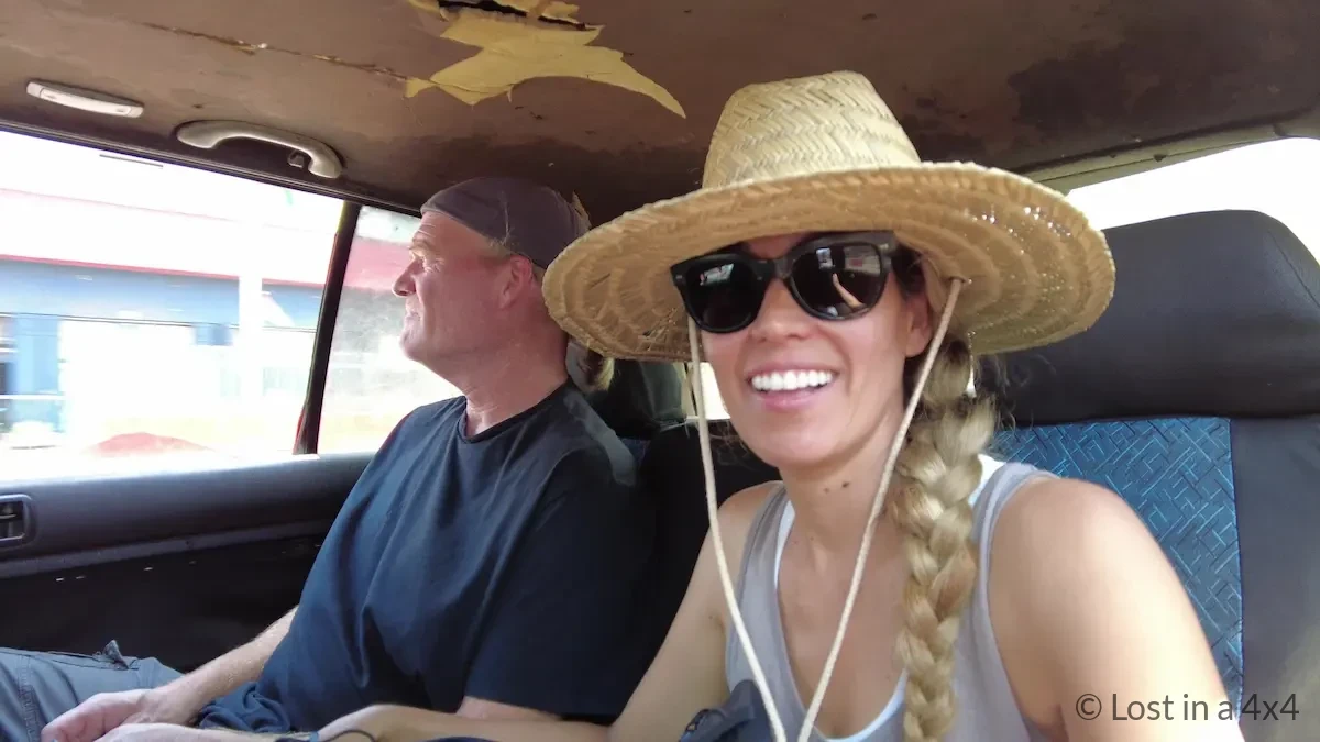 Brett and Karla sitting inside a taxi in Conakry, Guinea, traveling from the airport to downtown after getting an Ivory Coast visa sticker