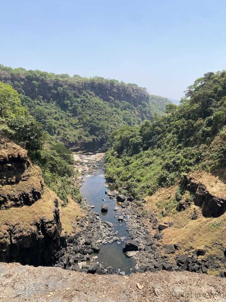 Standing on top of Kambadaga Waterfall in Guinea during dry season overlooking the river below.