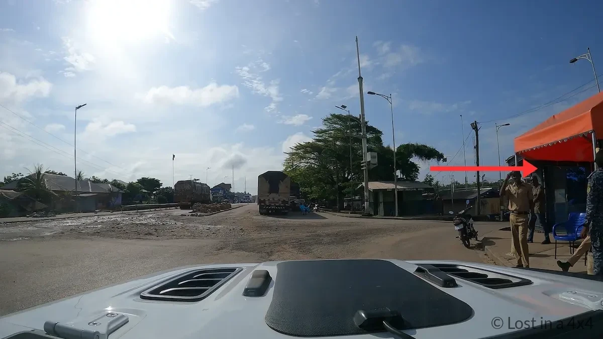 Blue immigration container office at Ghana border where passports are logged and entry receipts are issued at Noé–Elubo crossing.