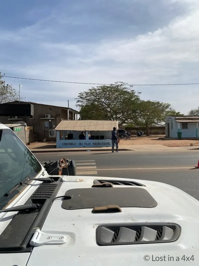 Jeep Wrangler Rubicon parked near the Contrôle du Flux Migratoire office at Sénoba Border Post in Senegal.