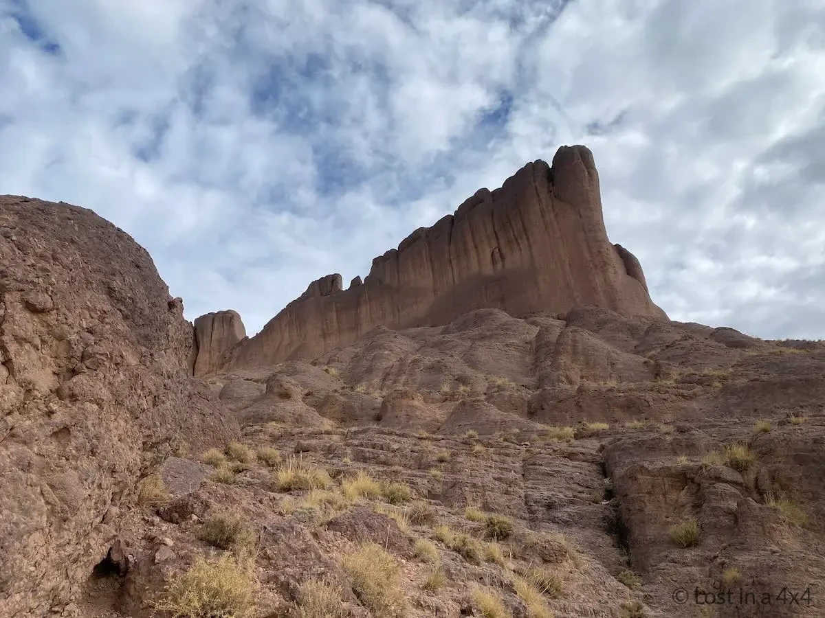 View of a massive rock formation from below during a climb near Pâte de l'Éléphant in Morocco.