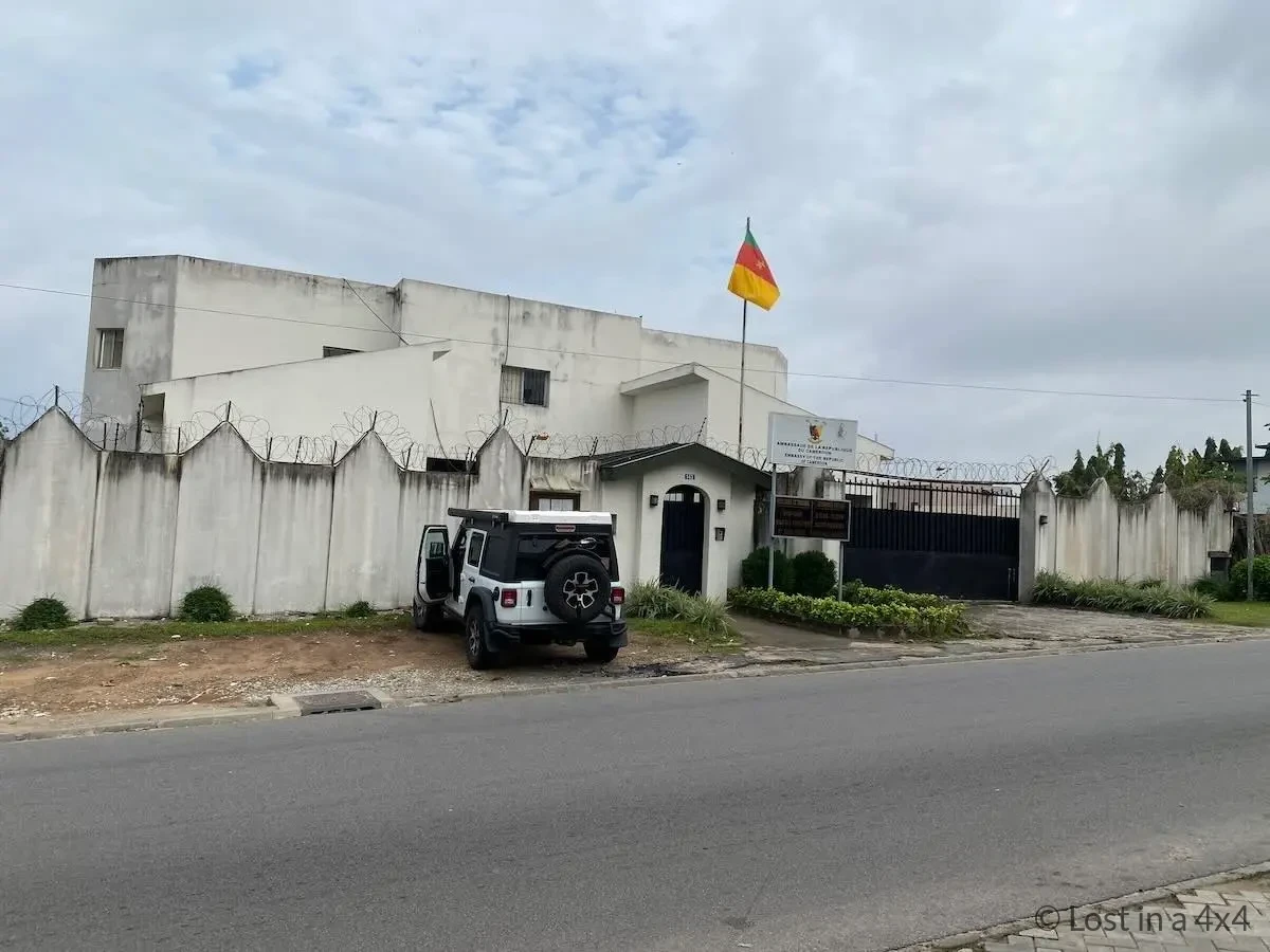 Our Jeep Wrangler parked outside the Cameroon Embassy in Abidjan, Côte d'Ivoire, where we received the Cameroon visa sticker after our eVisa approval.